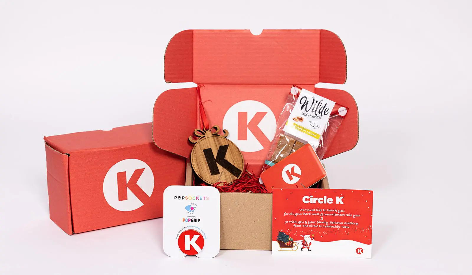 Circle K Christmas Appreciation Pack  with a red theme including a Christmas decoration, powerbank, fudge, popsocket and Christmas card.