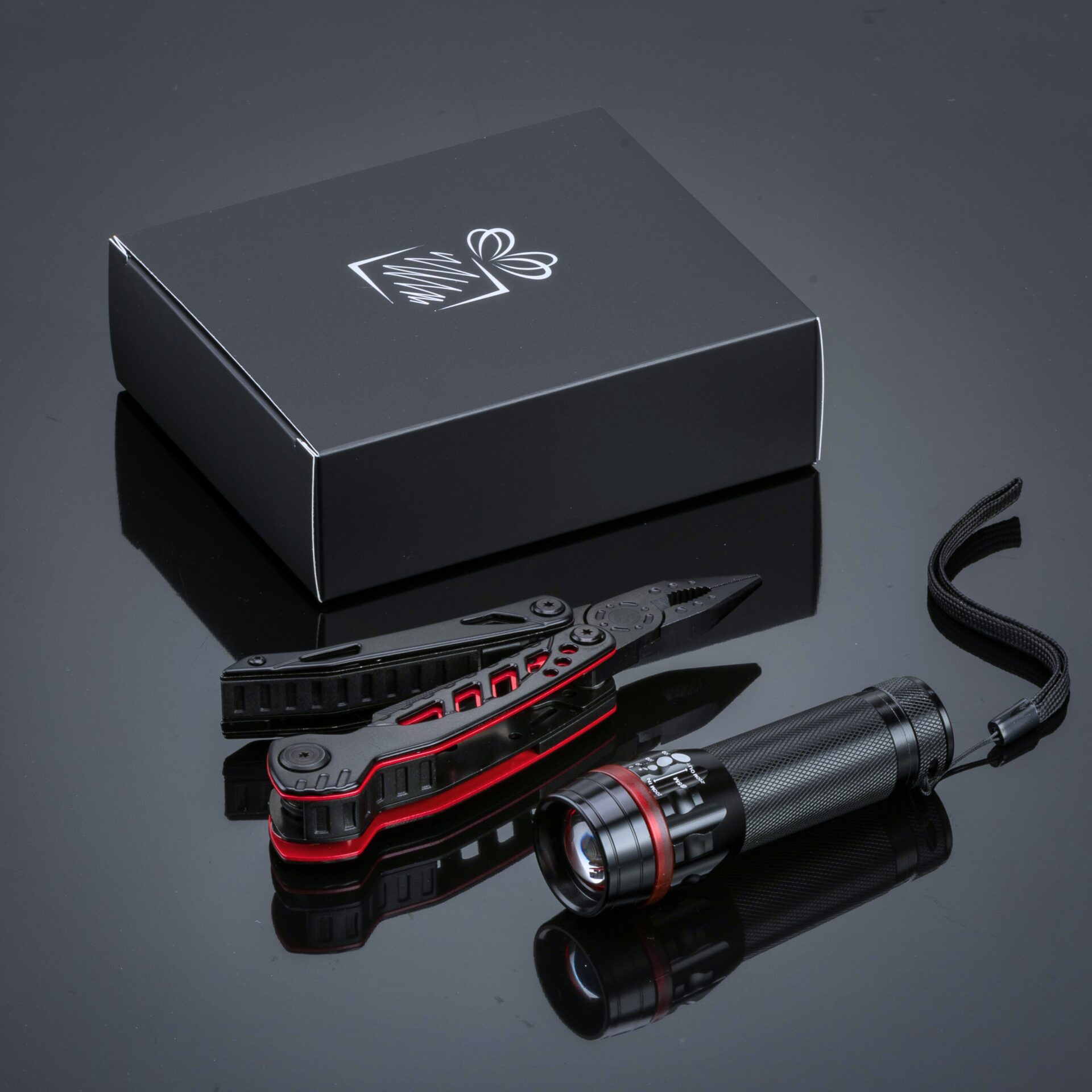 The Titanium coated Steel Optima Set multitool & flashlight in black with red accents together with a brandable gift box.